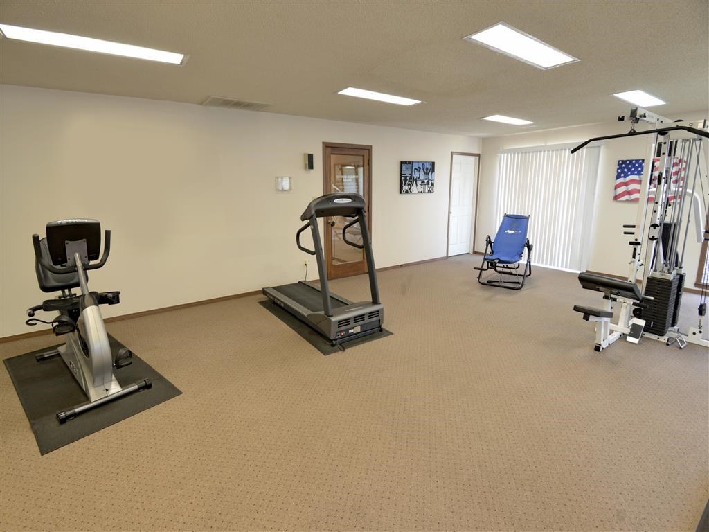 a gym with a lot of exercise equipment in a room