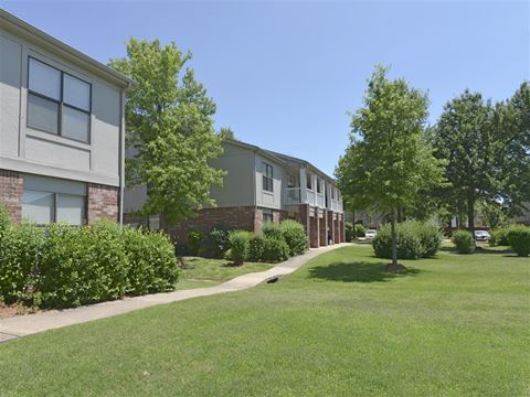 our apartments are located in a quiet neighborhood with green grass and trees
