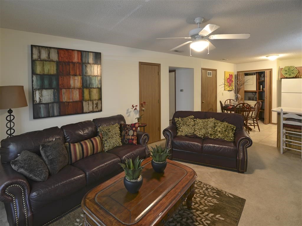 a living room with leather couches and a coffee table