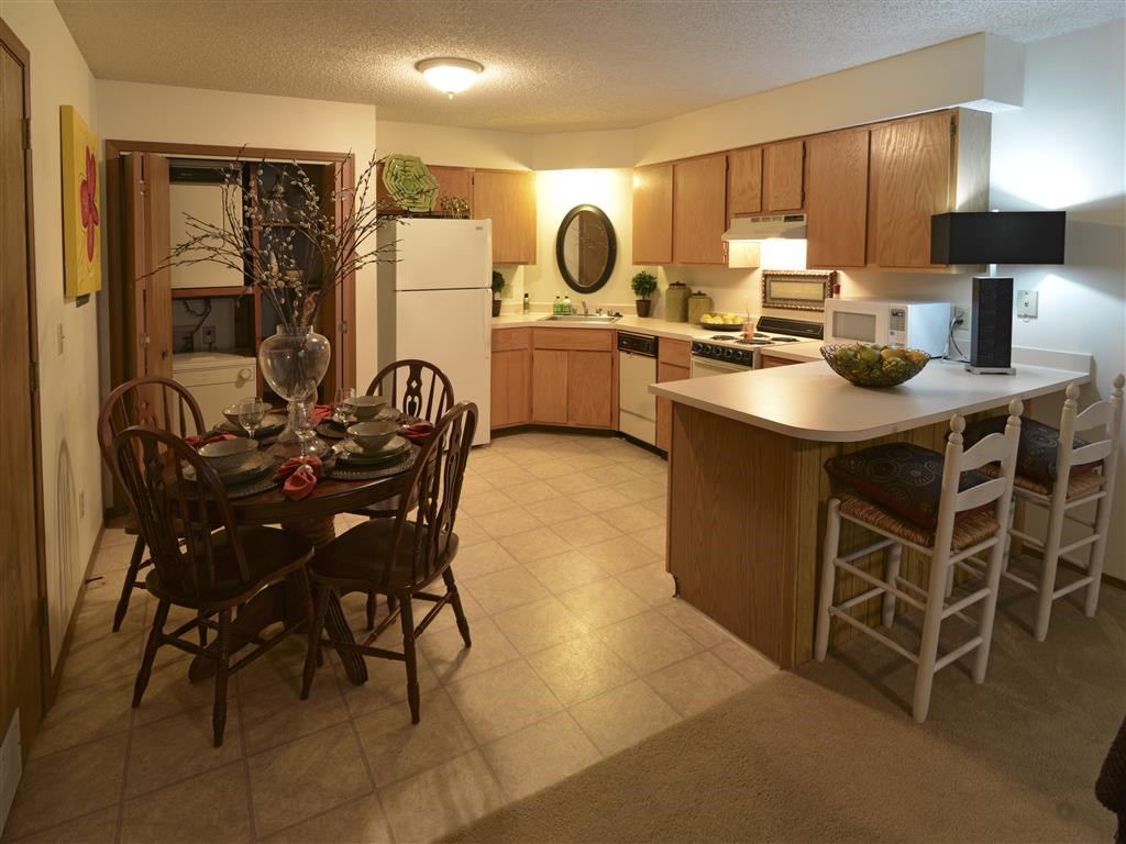 a kitchen and dining room with a table and chairs