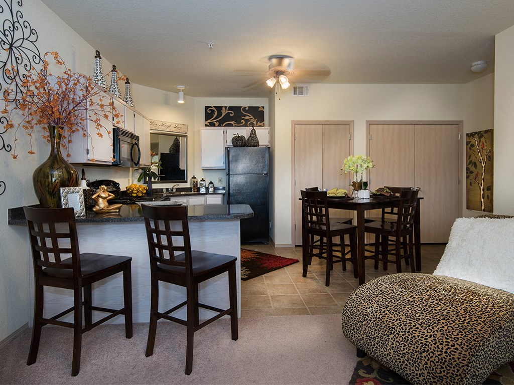 a living room and kitchen with a dining room table and chairs