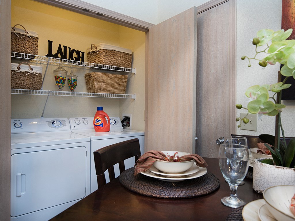a laundry room with a table and a washing machine
