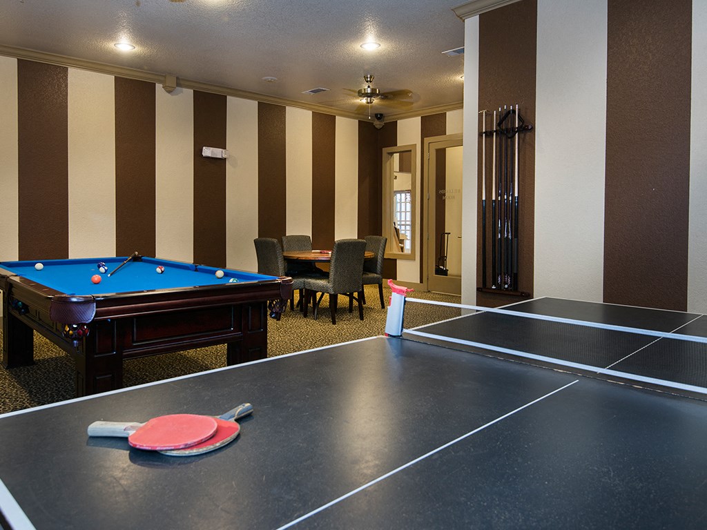 a game room with a pool table and ping pong