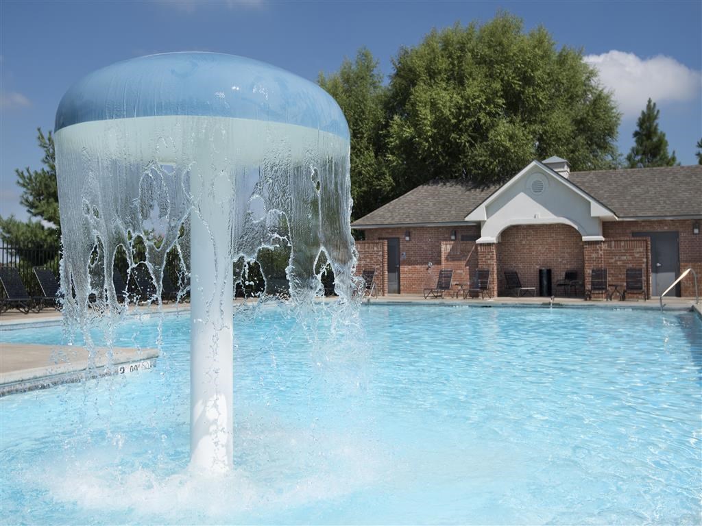 a water fountain in the middle of a pool