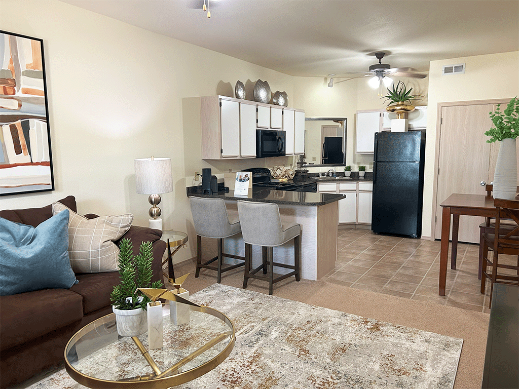 a living room with a kitchen and a table