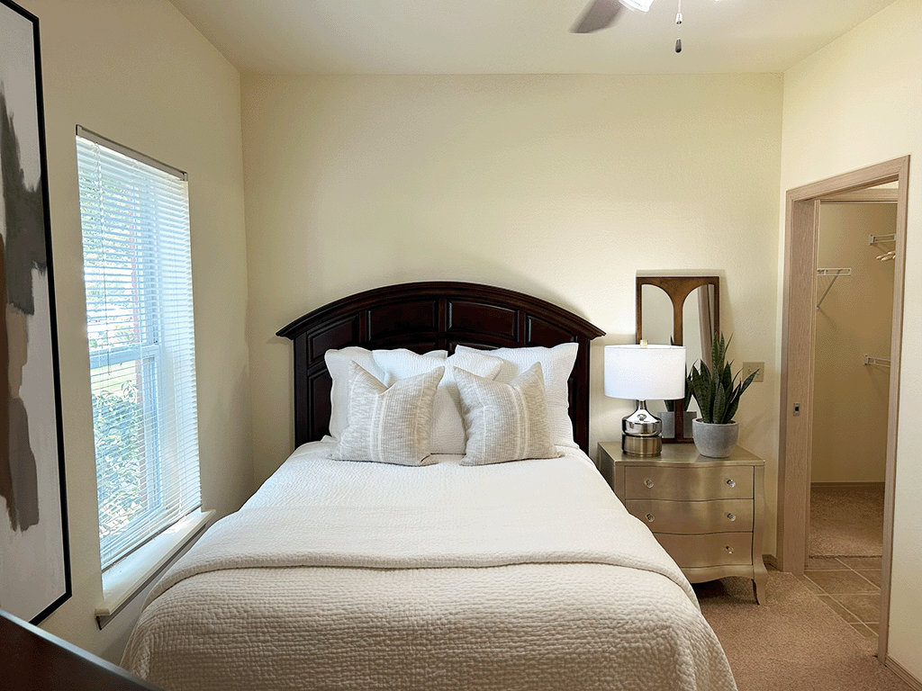 a bedroom with a large bed and a window