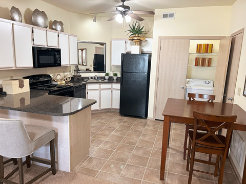 a kitchen with a dining table and a refrigerator