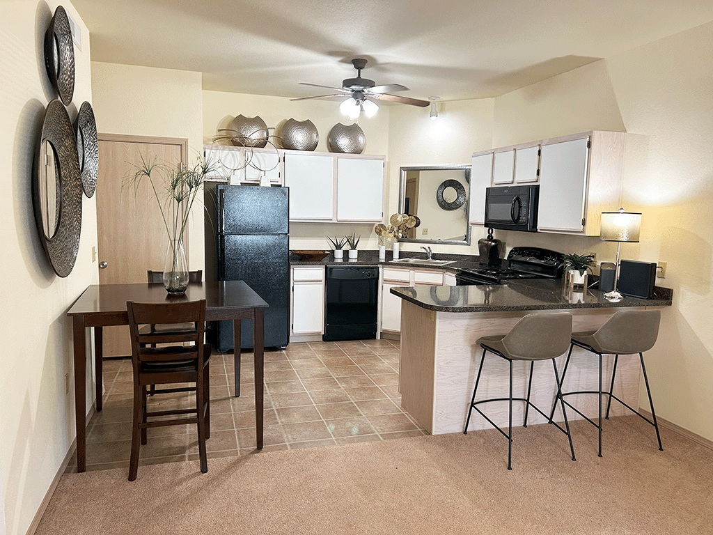 an open kitchen and dining area with a table and chairs