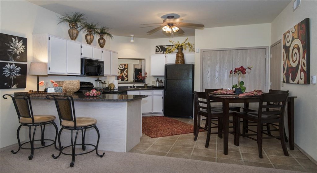 a kitchen and dining room with a table and chairs