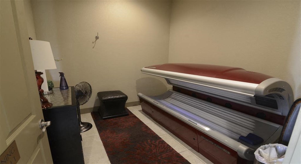 a small room with a bed in the corner