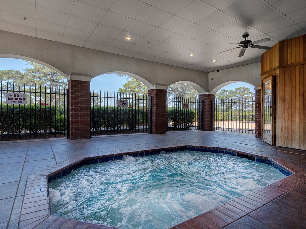 an indoor jacuzzi in a resort style swimming pool