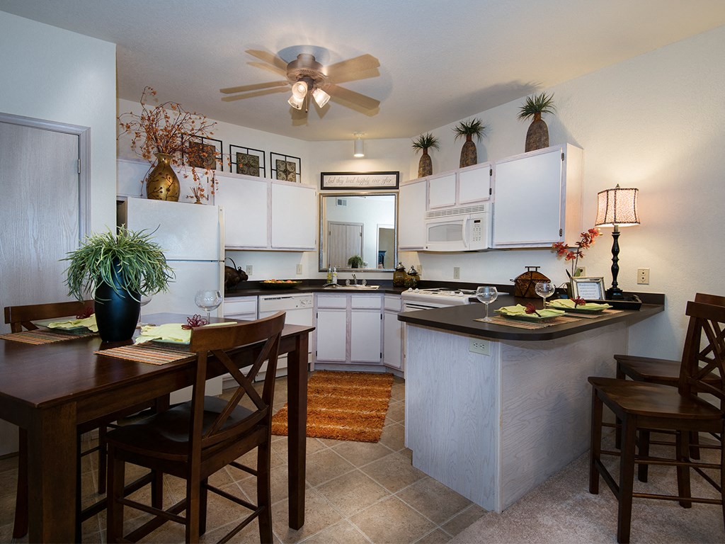 an open kitchen and dining area with a table and chairs