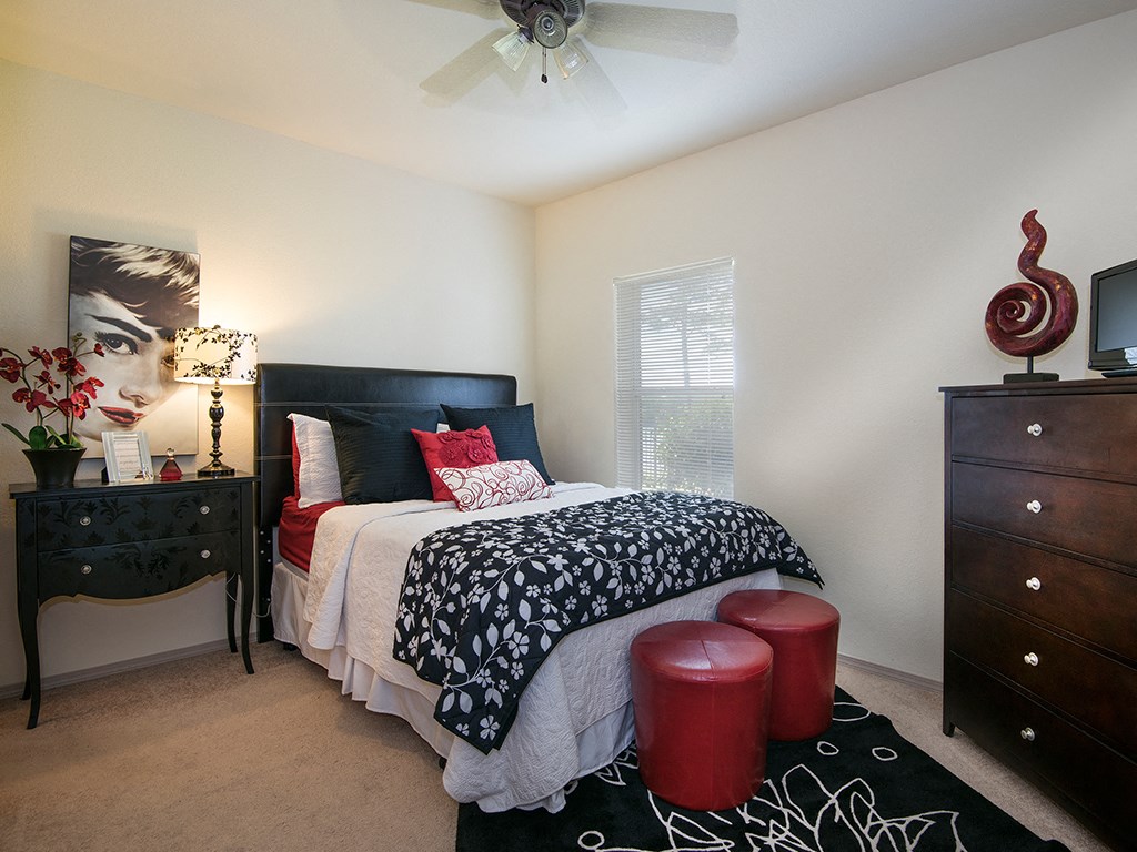 a bedroom with a bed and a ceiling fan