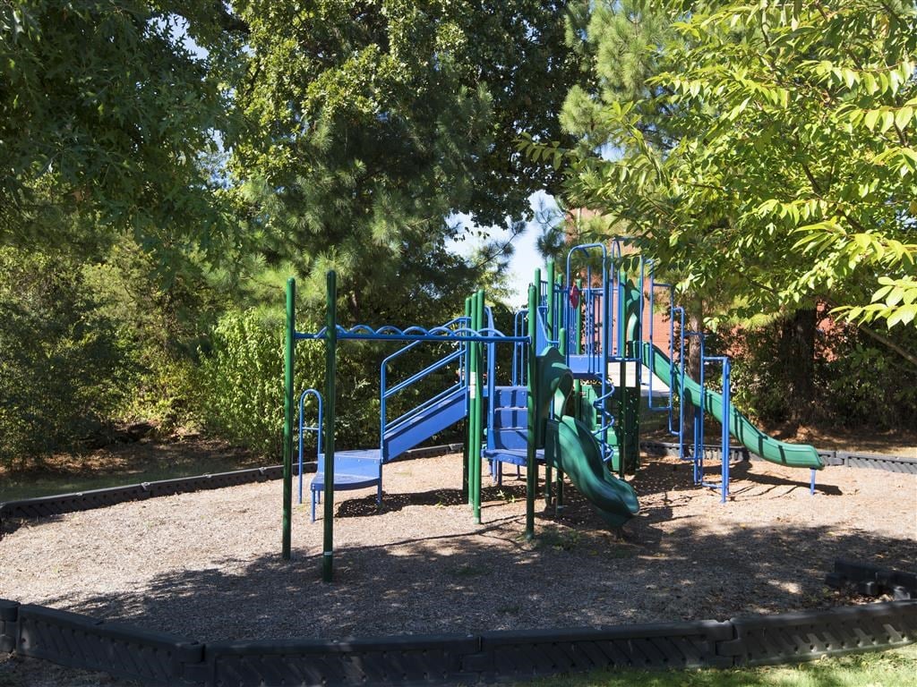 a playground with a slide in a park