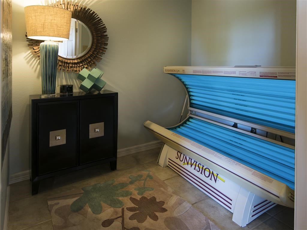 a spa room with a pool bench and a mirror