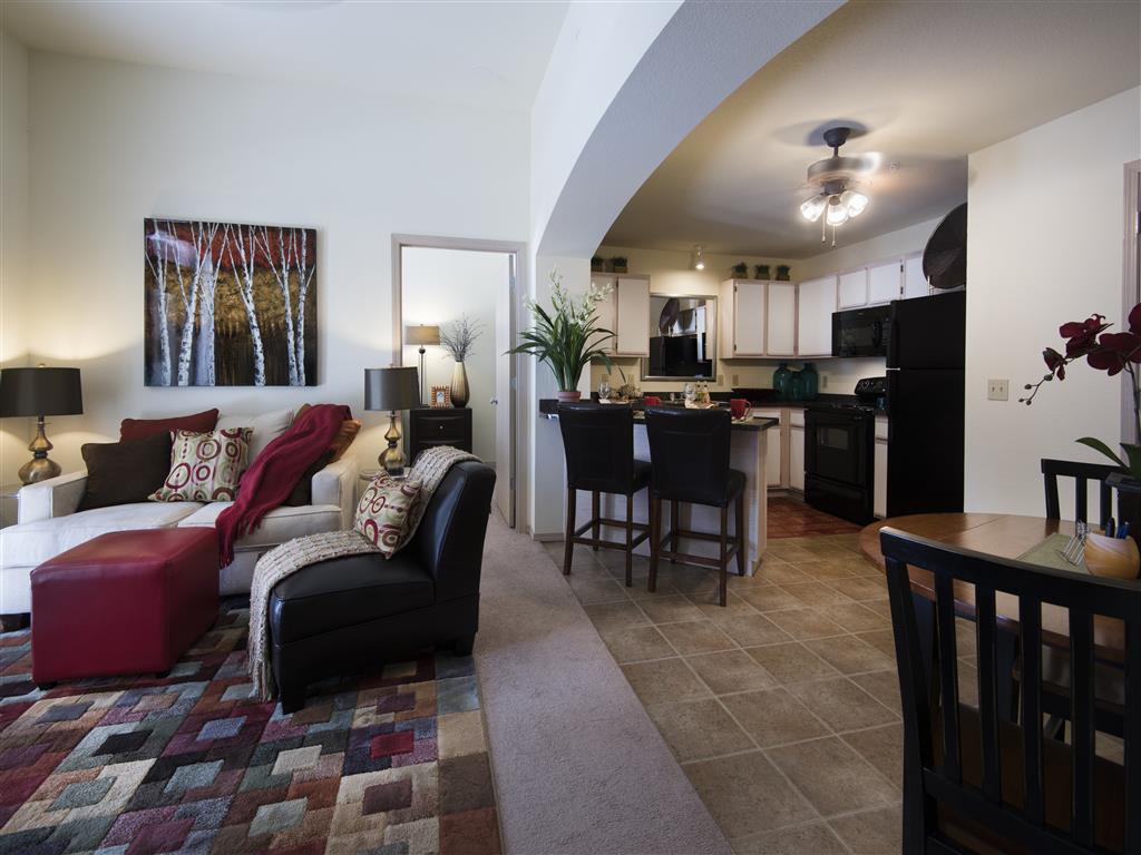 a living room and kitchen with a couch and a table