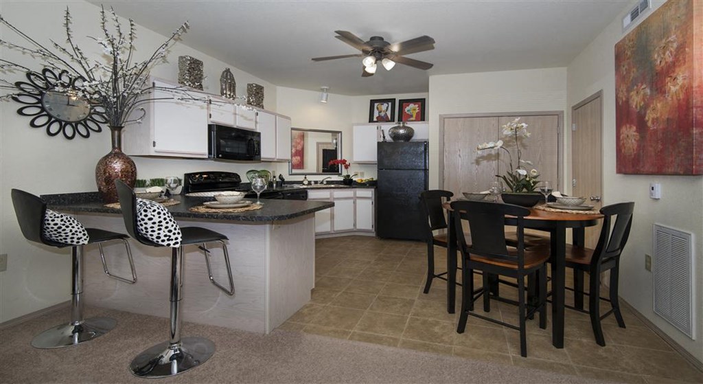 a kitchen and dining room with a table and chairs