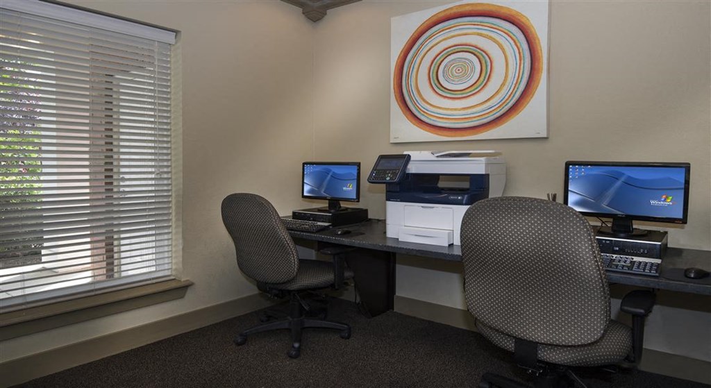 a office with two desks and two computer monitors