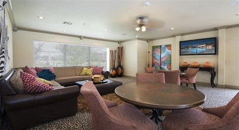 a living room with couches and chairs and a table