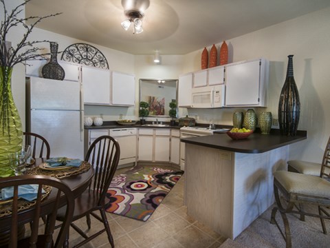 a kitchen and dining room with a table and chairs