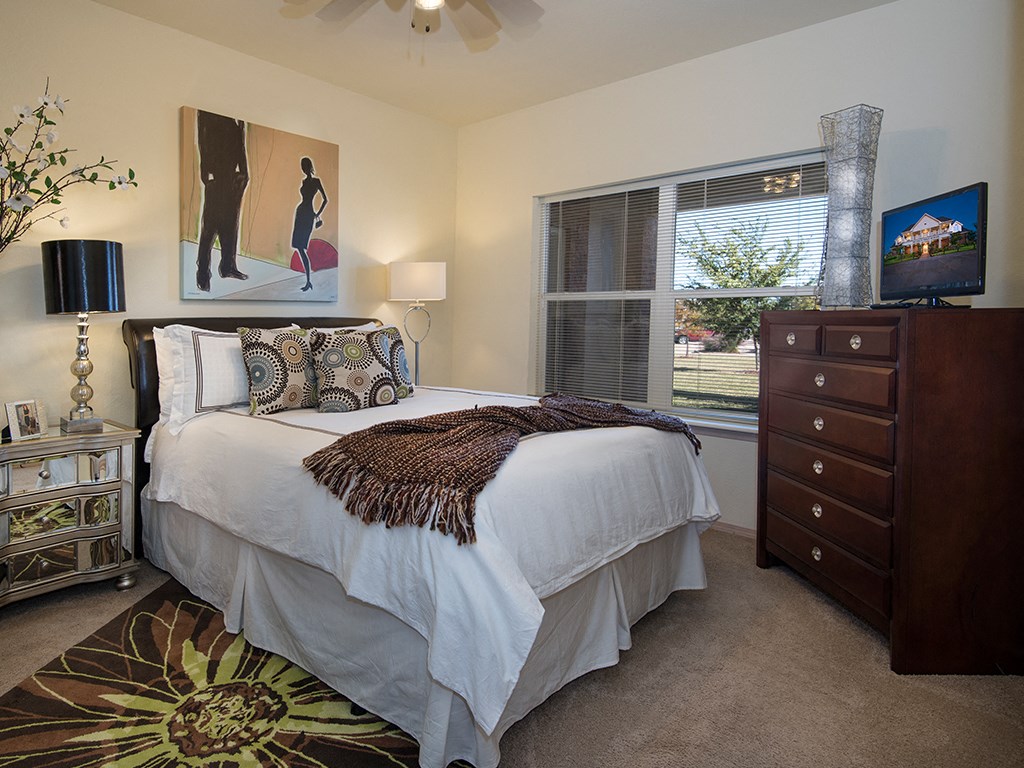 a bedroom with a bed and a window