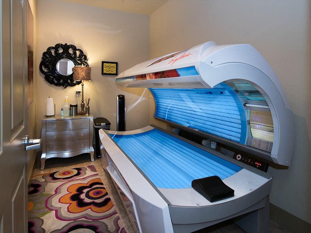 a patient room with a bed and a radiation therapy machine