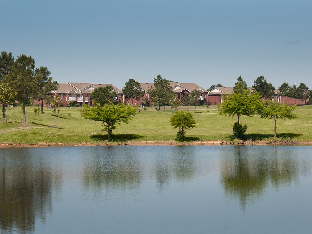 a view of a lake with houses in the background
