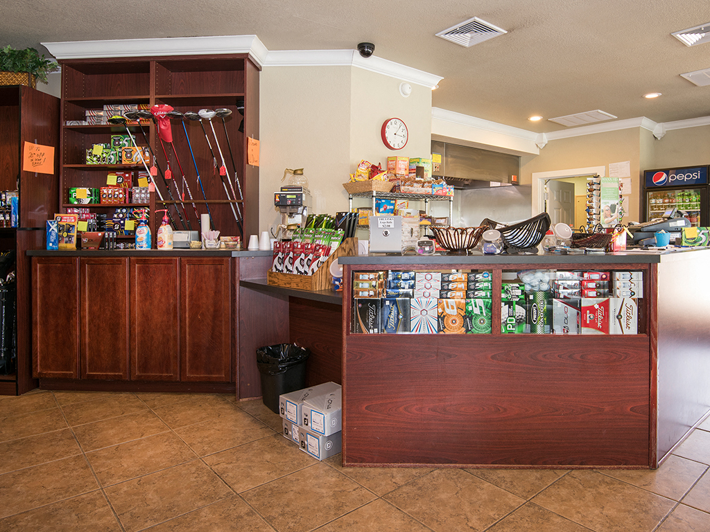 a coffee shop with a counter full of food and drinks