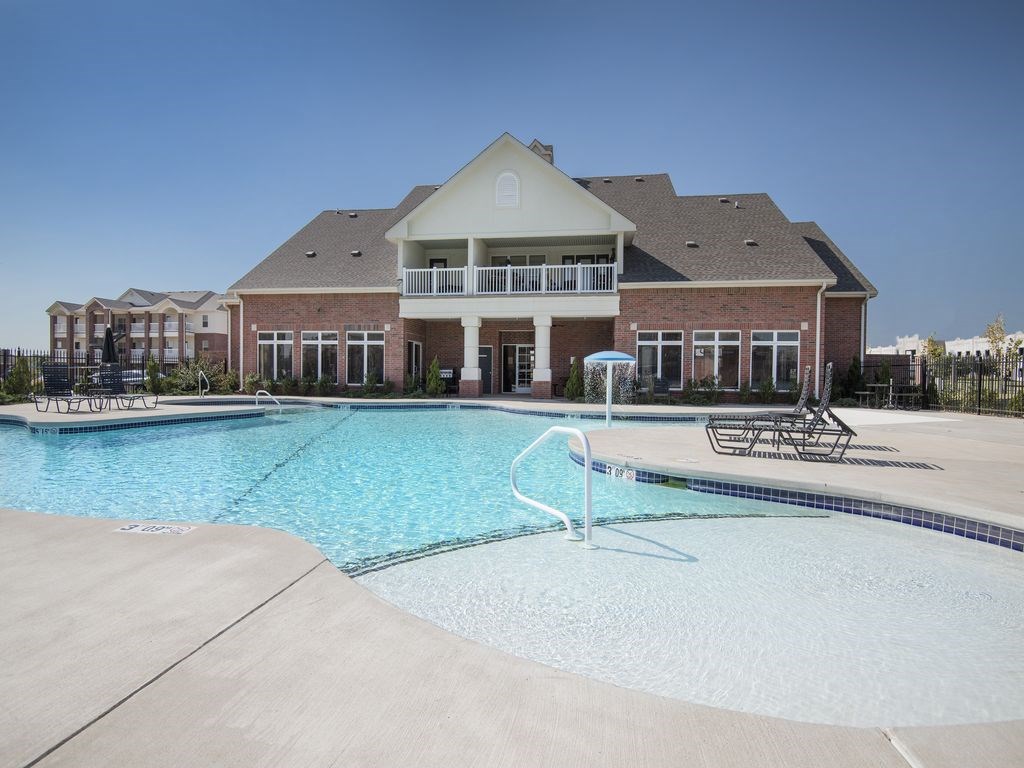 a swimming pool with a building in the background