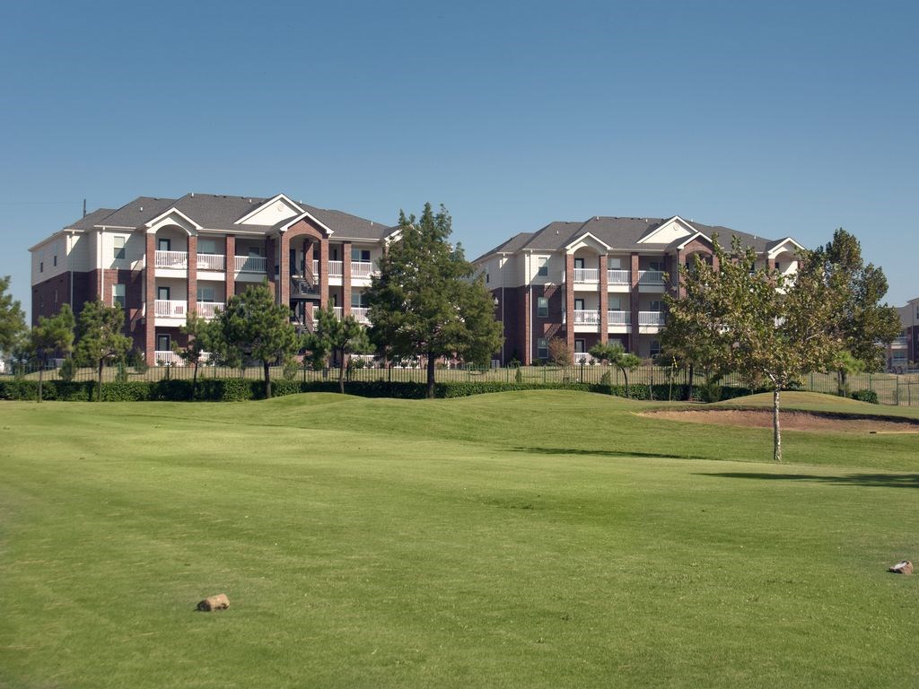 a golf course in front of an apartment building