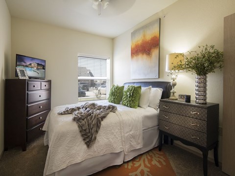 a bedroom with a large bed and a window