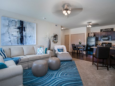 an open living room and dining room with a couch and a chair and a table