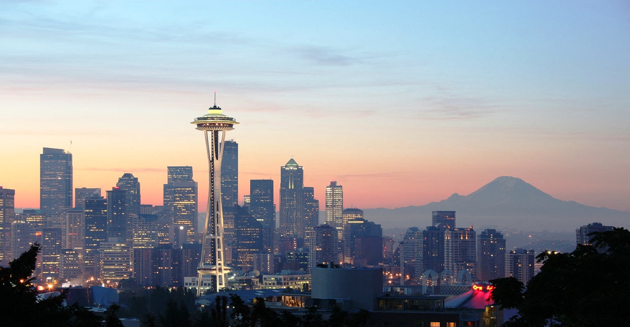 a view of the skyline with the space needle and mt rainier