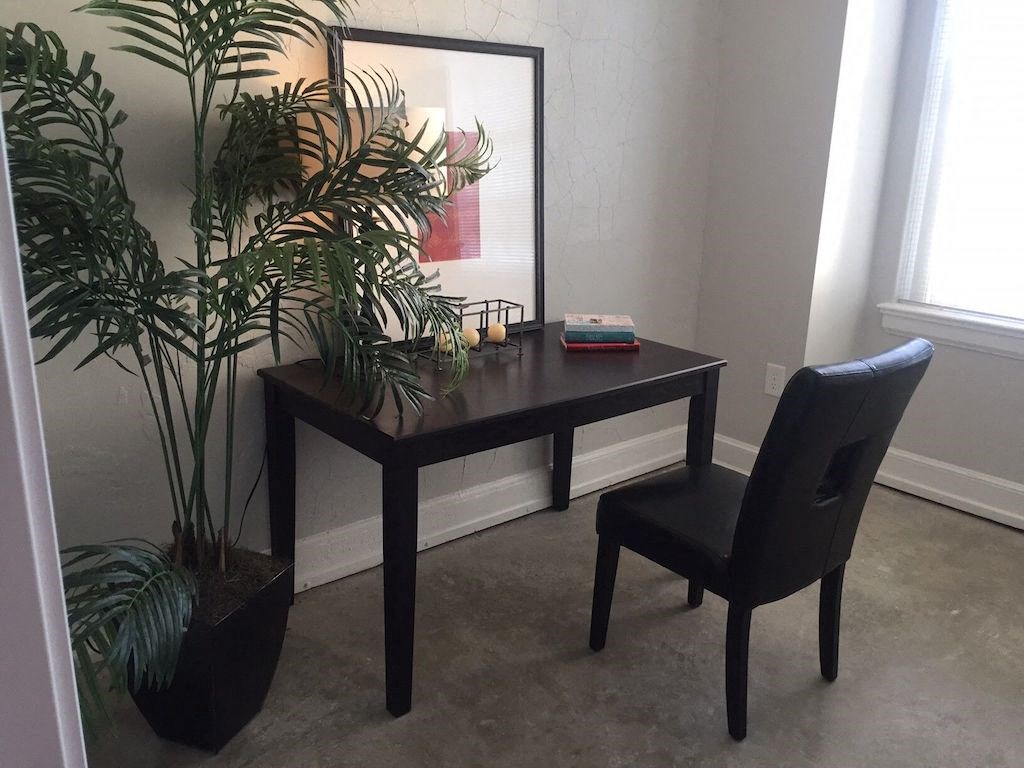 Home office with desk and chair in apartment at Thomas Jefferson Tower, Birmingham, AL