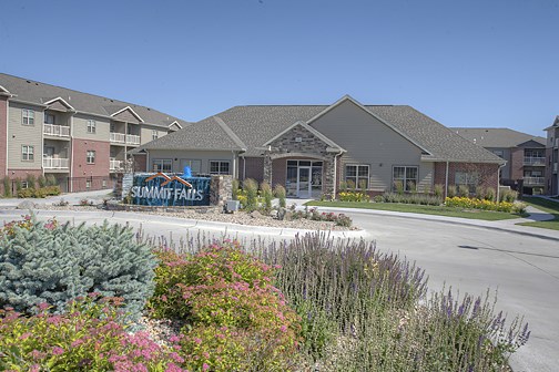 a building with a sign in front of a parking lot