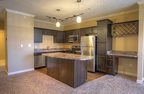 a large kitchen with stainless steel appliances and granite counter tops