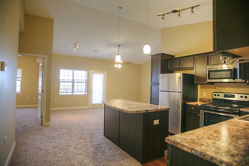 an empty kitchen with an island in the middle