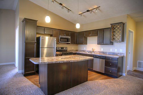 a kitchen with stainless steel appliances and granite counter tops