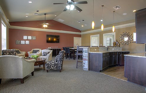 a living room with a kitchen and a dining room