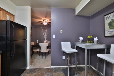 a kitchen and dining room with a refrigerator and a table