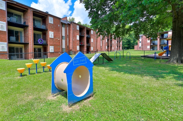 a playground in a yard in front of an apartment building