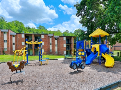 a playground in front of a brick building