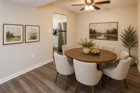 A dining room with a wooden table and chairs.