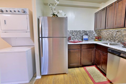 a kitchen with a stainless steel refrigerator and a sink