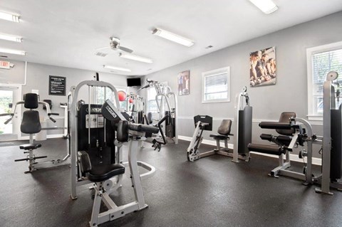 a gym with weights and other equipment in a building