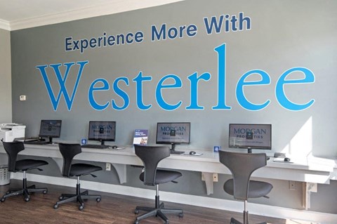 a wall with the words experience more with website and desks with computers