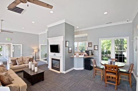 a living room with a fireplace and a dining room