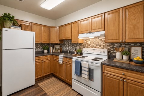 A kitchen with wooden cabinets and a white refrigerator.