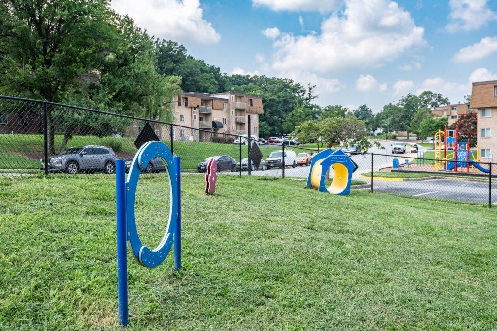 a playground at a park with a chain link fence