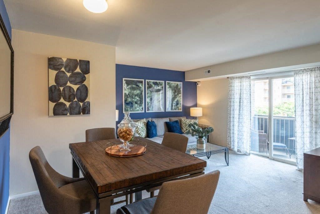 a dining room with a wooden table and chairs